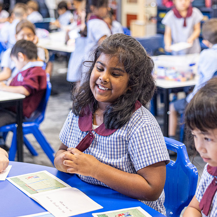 Student learning to read in the classroom at St John's Primary School Riverstone