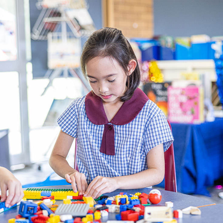 Student building lego in the classroom at St John's Primary School Riverstone