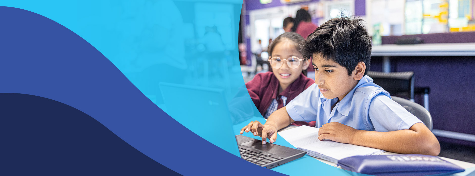 Students working together on the laptop in the classroom at St John's Primary School Riverstone
