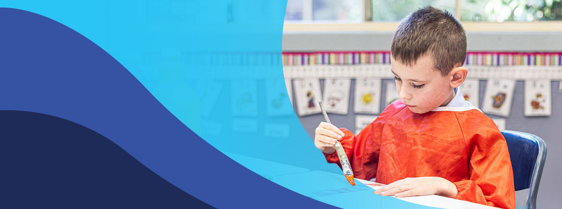 Student painting in the classroom at St John's Primary School Riverstone