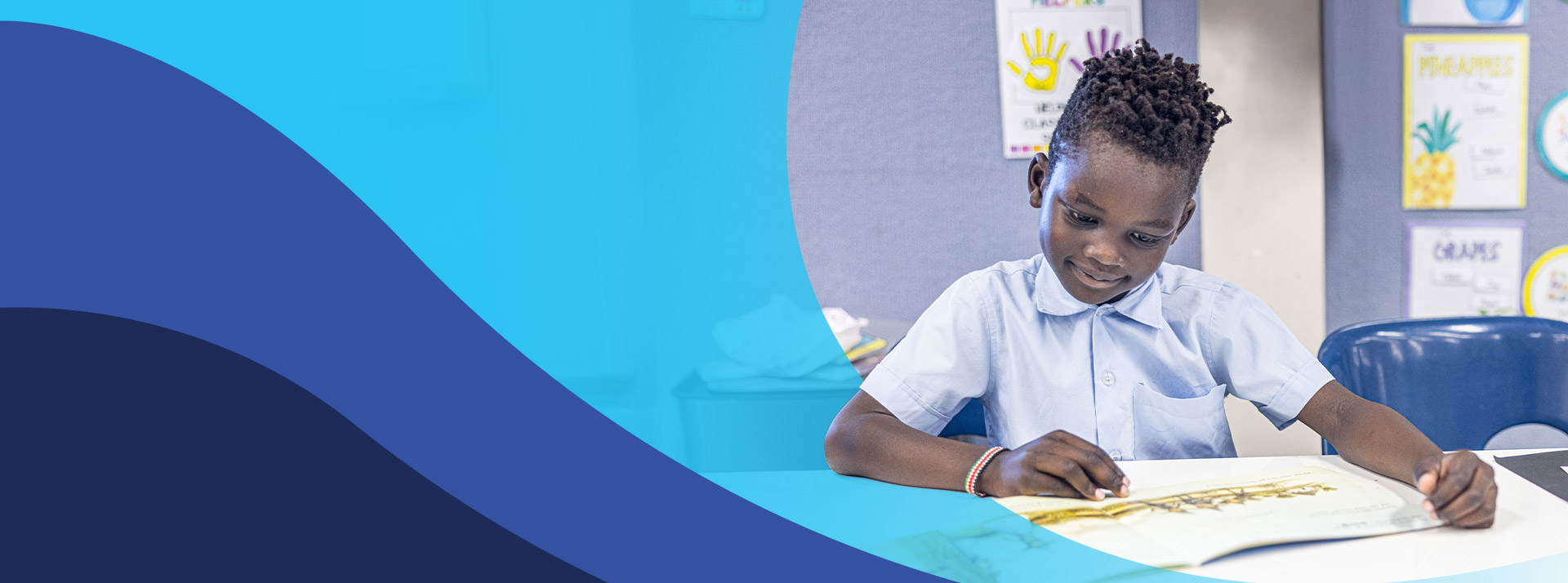 Student reading a book in the classroom a St John's Primary School Riverstone