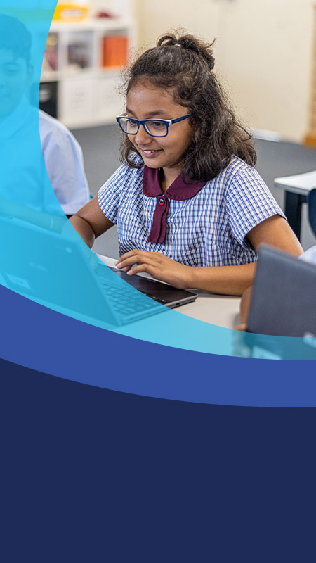 Student using her laptop in the classroom at St John's Primary School Riverstone