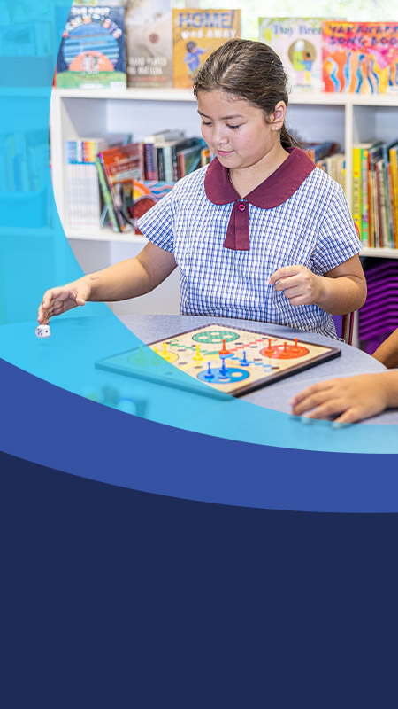 Students playing a game together in the classroom at St John's Primary School Riverstone