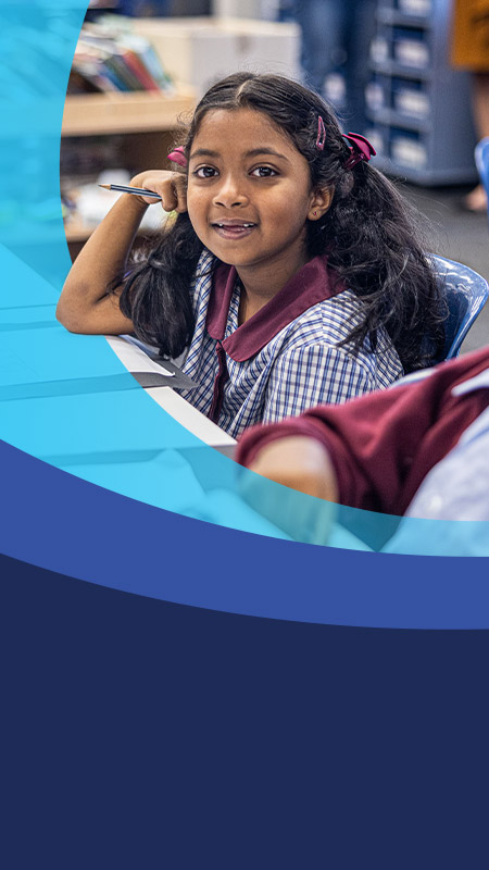 Student smiling in the classroom at St John's Primary School Riverstone
