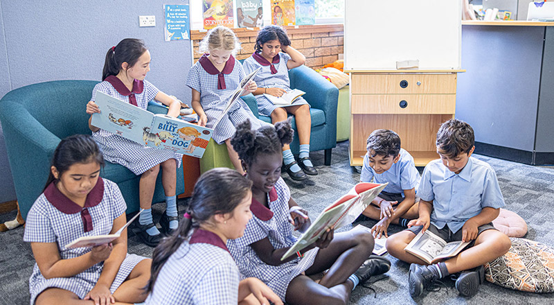 Students reading books in the library together at St John's Primary School Riverstone