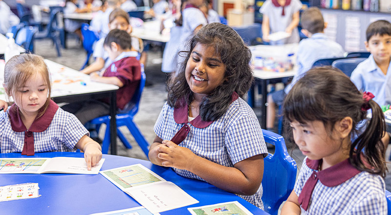 Student reading at her desk in the classroom at St John's Primary School Riverstone