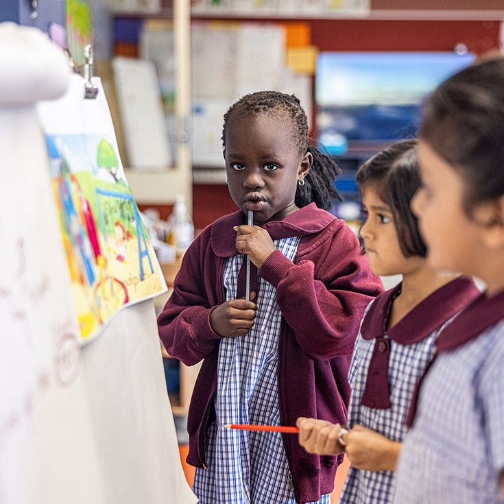 Student with her classmates in the classroom at St John's Primary School Riverstone