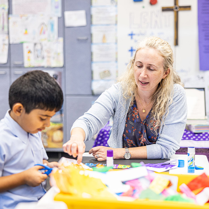 Teacher working with her student in the classroom at St John's Primary School Riverstone