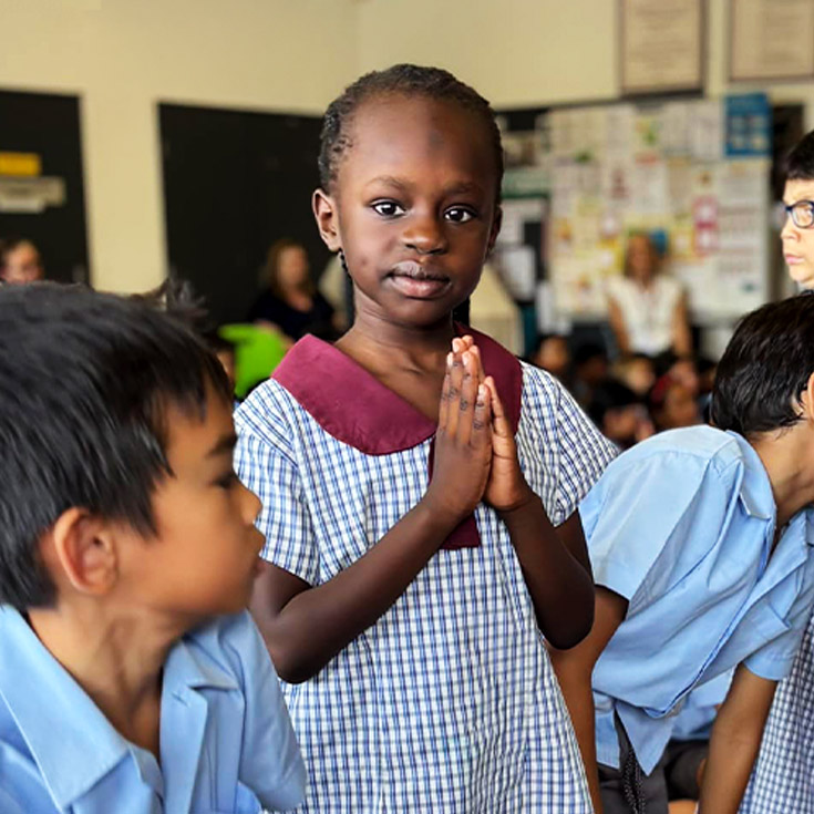 Student in prayer at an event at St John's Primary School Riverstone