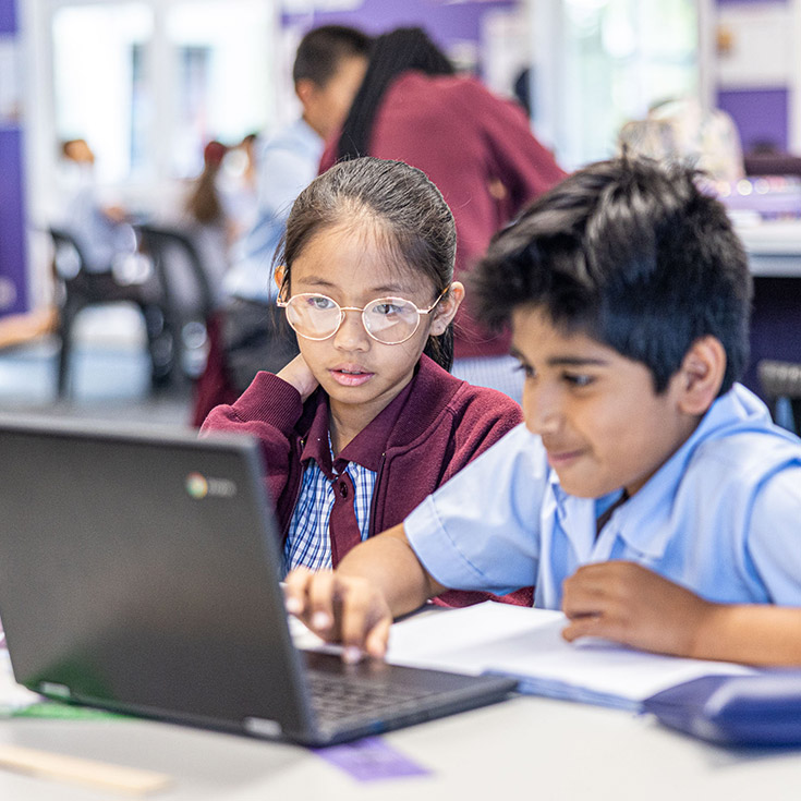 Students working together on their laptop in the classroom at St John's Primary School Riverstone